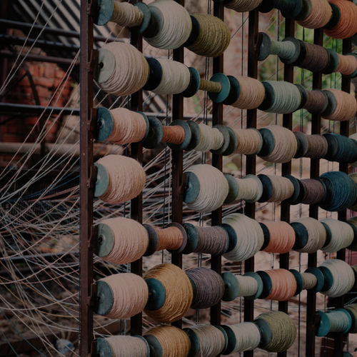 Spools of yarn arranged for weaving