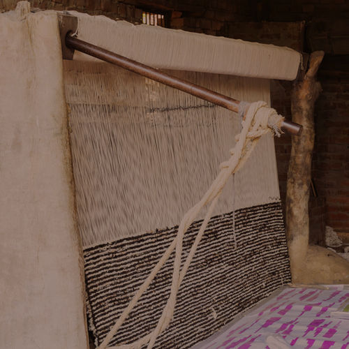 A rug in progress on a wooden loom